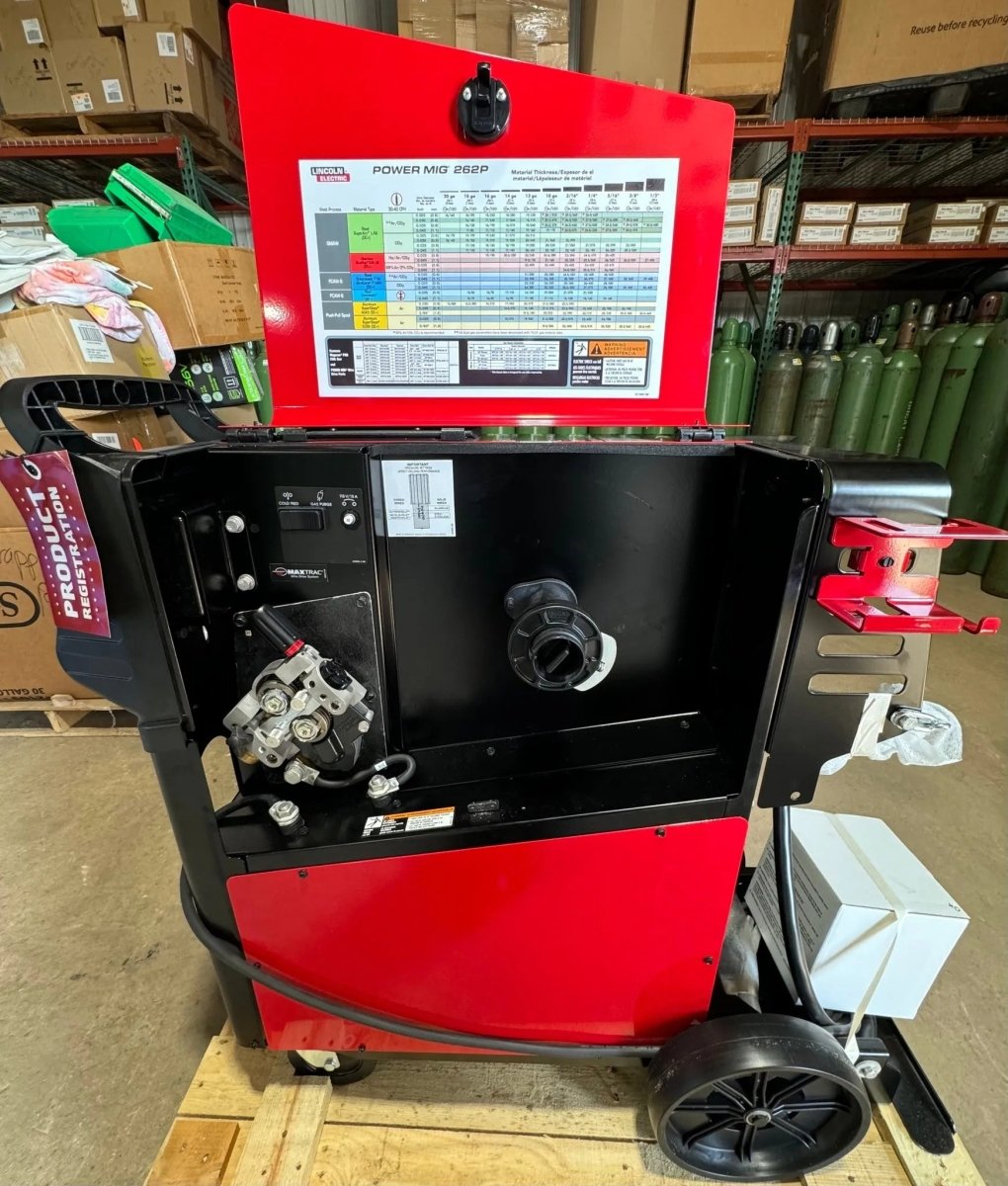 Lincoln POWER MIG 262P Welder Demo U5378-1 open front, showing components and lid chart; welding equipment in warehouse setting.