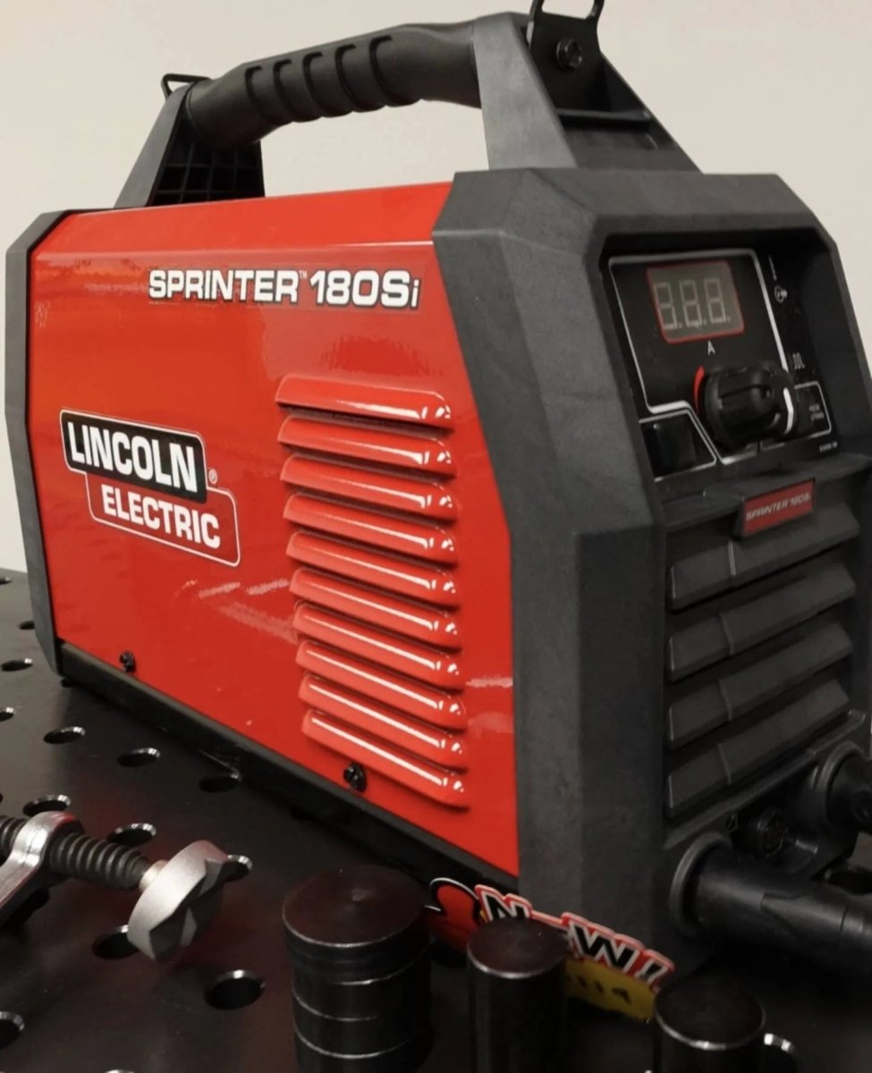 Lincoln Sprinter 180Si Factory Demo Welder U5453-1 on metal workbench with welding tools, parts at WeldingMart.