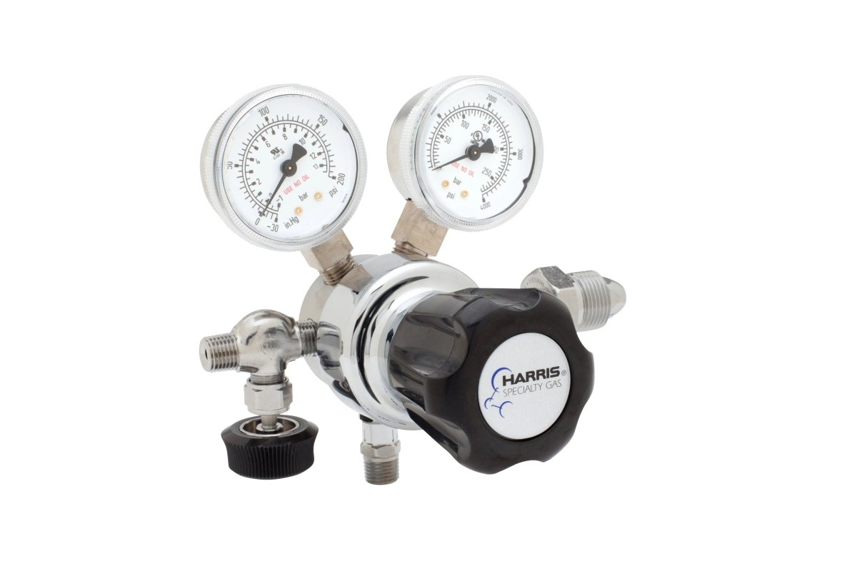 The Harris 701-125-580-A regulator features two round pressure gauges, a black adjustment knob, and multiple connection valves, ideal for laboratory use with argon, helium, neon, or nitrogen. Set against a white background.