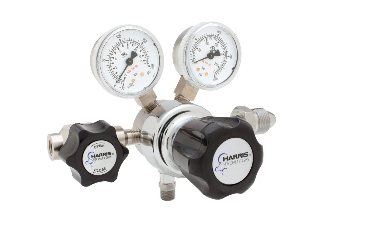 The Harris 701-125-580-B Argon/Helium/Neon/Nitrogen Regulator is a single-stage cylinder regulator for laboratory use with two pressure gauges, black OPEN/CLOSE control knobs, and the HARRIS Specialty Gas logo on a white background.