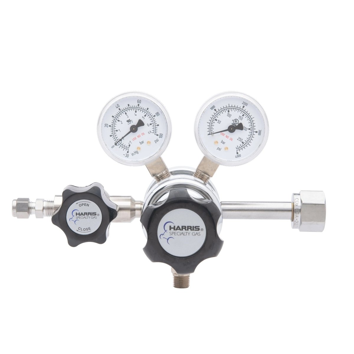 The Harris HP702-050-320-BE Carbon Dioxide Regulator is a dual-gauge, two-stage cylinder regulator featuring two round pressure dials, a control knob marked open/close, and metallic connectors.