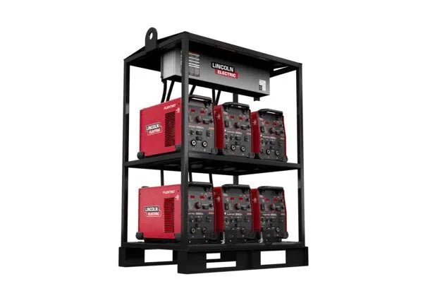 A black rack holds six red and black Lincoln Flextec 350X PowerConnect welders in two rows of three, plus a white device on top. The Lincoln Flextec 350X PowerConnect 6-Pack Rack (K4727-2) sits on a pallet against a plain white background.