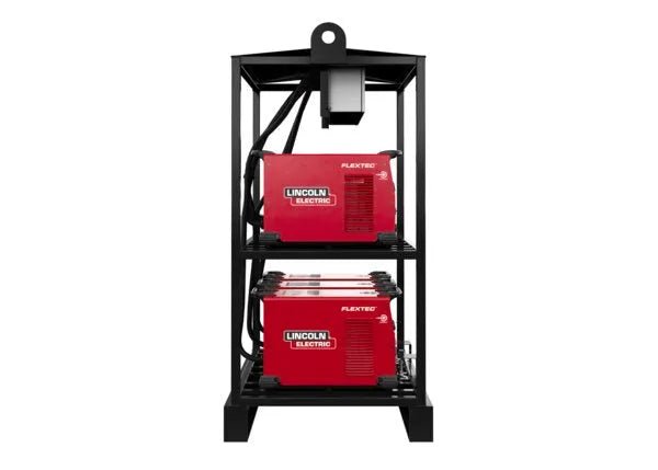 A black metal welding rack (Lincoln Flextec 350X PowerConnect 6-Pack Rack - K4727-2) holds two red Flextec 350X machines, each on separate shelves. A top hook allows lifting, and cables are coiled beside each unit. Background is plain white.
