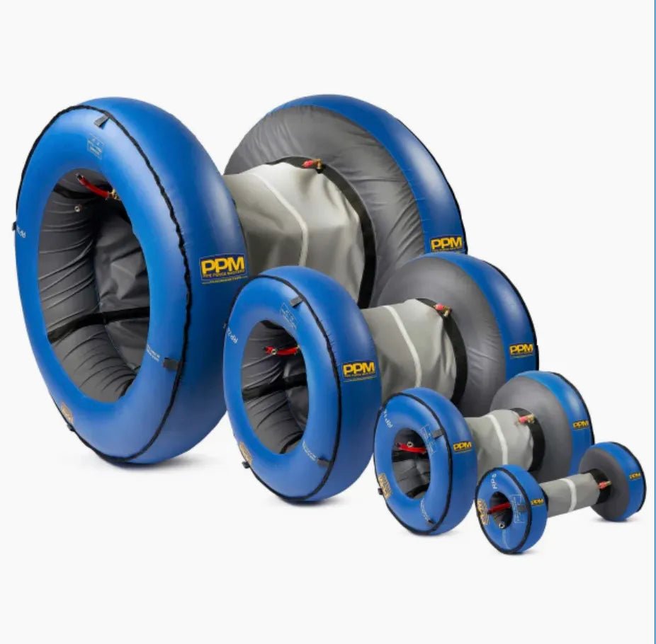 Seven Mathey Dearman Rapid Purge System - Inflatable System 572-597mm 24 - RP24 plugs, in blue and gray with yellow PPM logos, are displayed in a diagonal row by size, showing front and side views with gray centers and blue rims.