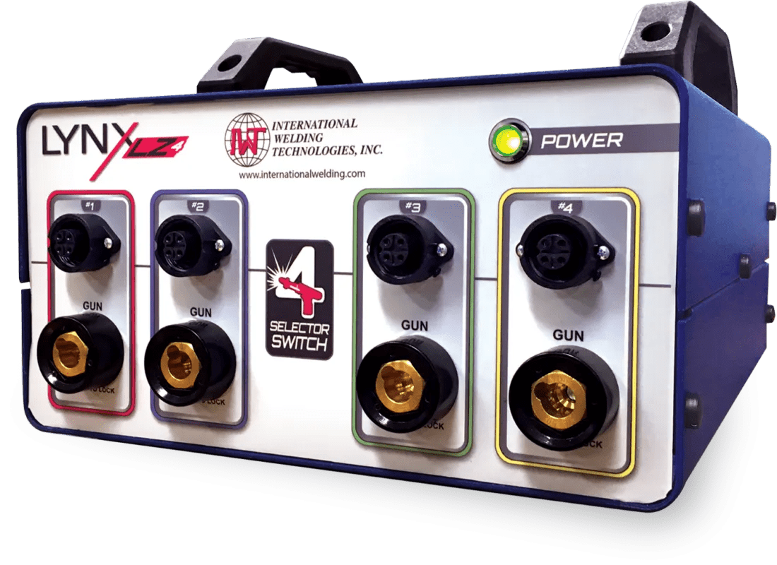 The IWT LZ-4 Switch Box (1-IWT500056L) is a rectangular unit with four labeled connectors for welding guns, each with a round port, black knob, and yellow ring. It features a power button and displays the International Welding Technologies logo.