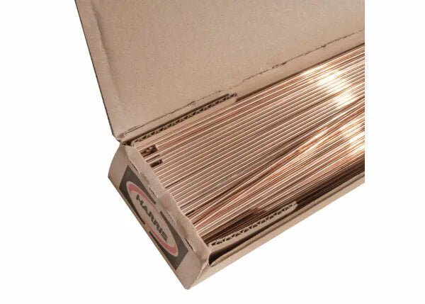 A plain cardboard box with a small label contains neatly stacked Harris 0 Phos Copper Brazing Alloy rods, 1/8 x 36, 25 lb (0636R), ideal for copper-to-copper applications or use as a phos copper brazing alloy.