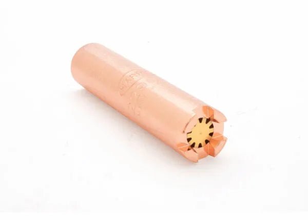 A copper-colored cylindrical shotgun shell with a crimped, star-shaped closure at one end, similar in size to a heavy-duty heating tip, lies on a white background.