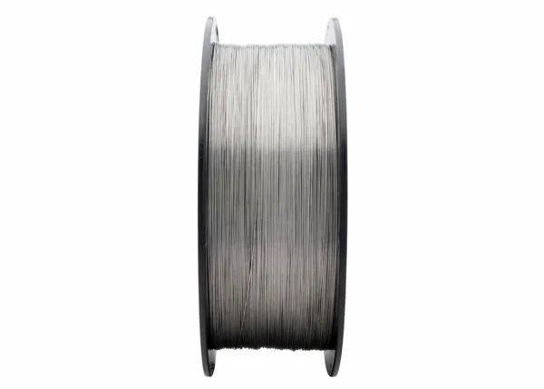 A close-up of a Harris 308LT1-1 Dynacore Stainless Flux-Cored FCAW Welding Wire (.035 x 25# Spool, 308LFCF8) shows shiny wire wound evenly around a black plastic reel, standing out against a white background with both reel sides visible.