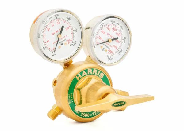 A brass Harris High-Pressure Oxygen Regulator with two gauges and a green label, designed for controlling and monitoring gas flow in high-flow cylinder applications. The front gauge shows delivery pressure; the top displays tank pressure.