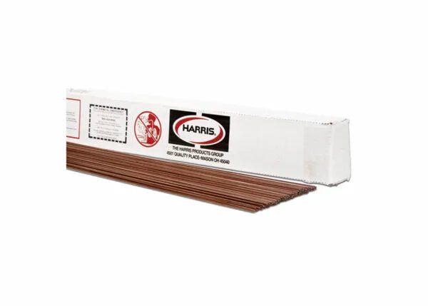 A white rectangular box labeled Harris 3AH Air-Hardening Tool Steel TIG GTAW Welding Rod 3/32 5# PKG - 003AH50 holds several long welding rods, partially pulled out. The box displays safety symbols and text, and sits on a plain white background.