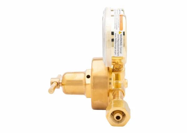 A brass single stage regulator with a pressure gauge, showing a side view. The industrial gas regulator features a cylindrical body, valve handle on the left, and threaded connector on the right.