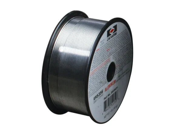A spool of Harris 5356 Aluminum MIG Welding Wire (3/64", 1 lb, #0535621) is wound on a black plastic reel. The shiny aluminum-magnesium wire has a red "ALUMINUM" label and a central hole for mounting.