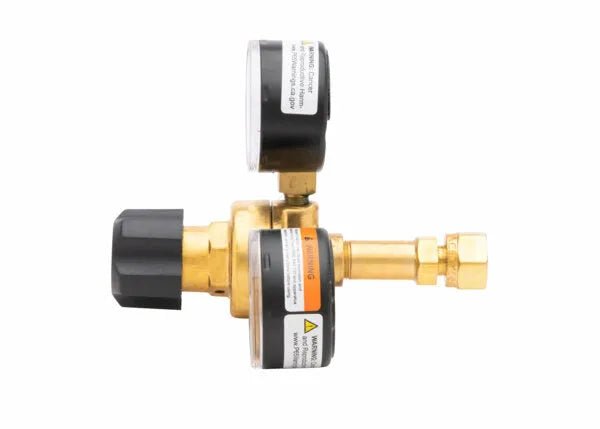 Harris 601-15-520-B acetylene regulator with brass body, dual black gauges, and knob for welding tools on white background.