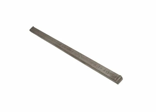 A metal meter stick with engraved markings lies diagonally on a white background. Its slightly worn surface is reminiscent of tools used in electronic soldering, such as the Harris 60401B 60/40 Leaded Bar Solder - 1 lb Bar.