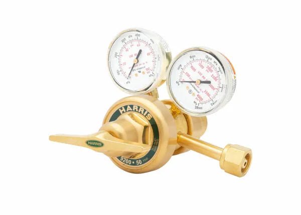 A brass Harris oxygen regulator with two pressure gauges and a control knob, designed for precise gas flow control in welding applications and laboratory industrial settings, shown on a white background.
