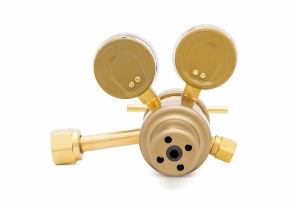 A brass two stage regulator with two round pressure gauges and adjustment knobs, viewed from the front against a white background—ideal for precise laboratory applications.