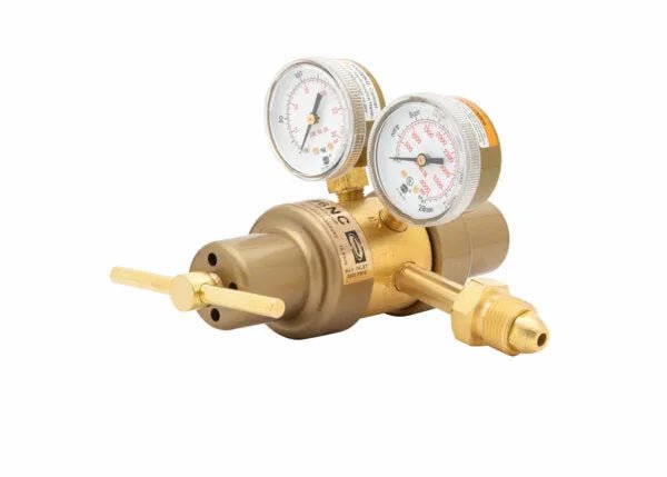 Brass gas pressure regulator with two gauges and a control valve, isolated on a white background. This Harris 9296 two stage regulator is ideal for controlling argon, helium, or nitrogen flow, with gauges displaying precise pressure readings.