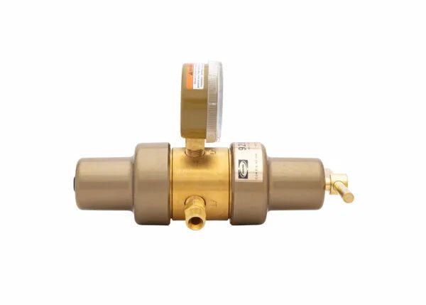 A brass laboratory regulator with a pressure gauge on top and valve connections on either side, isolated on a white background.
