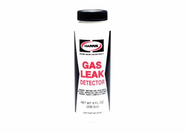 An 8 fl.oz. white cylindrical bottle with a black cap, labeled Harris Gas Leak Detector LEAK8. Contains a soapy solution for detecting leaks in pressurized gas systems. Branding, warnings, and instructions are printed in red and black on the label.
