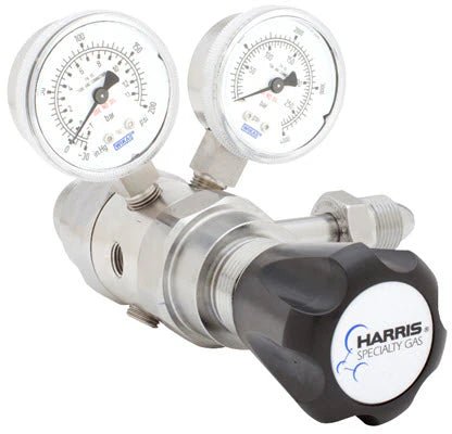 The Harris 742-125-580-C Regulator is a stainless steel cylinder regulator for Argon, Helium, Neon, or Nitrogen. It has dual pressure gauges (psi/kPa), a black control knob labeled Harris Specialty Gas, and cylinder connection ports.