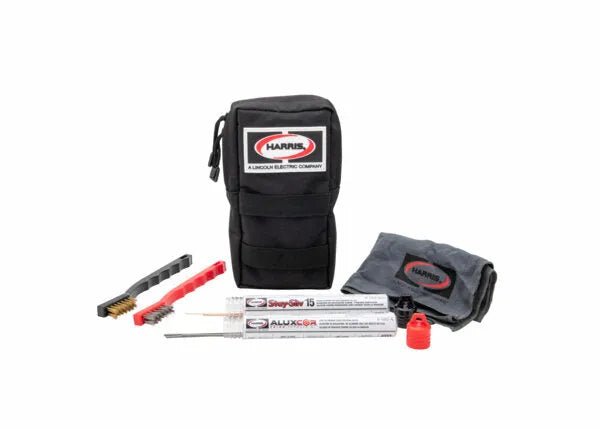 The Harris H-1000-B black HVAC brazing repair kit pouch stands upright with a black cleaning brush, red tool, Stay-Silv 15 and Aluxcor tubes, and a gray Harris cloth neatly arranged in front on a white background.