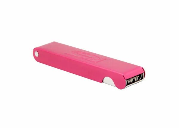 A compact, rectangular pink nail clipper with a shiny silver blade on one end, placed on a plain white background. Its modern, colorful look is as sleek as the Harris King Tip Cleaner - 2010690.