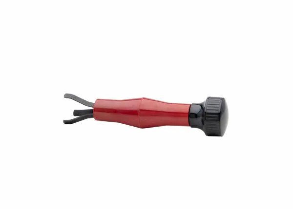 The Harris MIG Nozzle Cleaner - 3060030 features a shiny red hexagonal handle, black grooved cap, and two short curved prongs—perfect for gripping or pulling spatter from MIG nozzles; shown isolated on a white background.