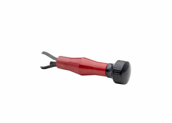 The Harris MIG Nozzle Cleaner - 3060030 is a compact hand tool with a red handle and black, forked metal tip, shown horizontally on a white background with the metal tip pointing left and a rounded black end.
