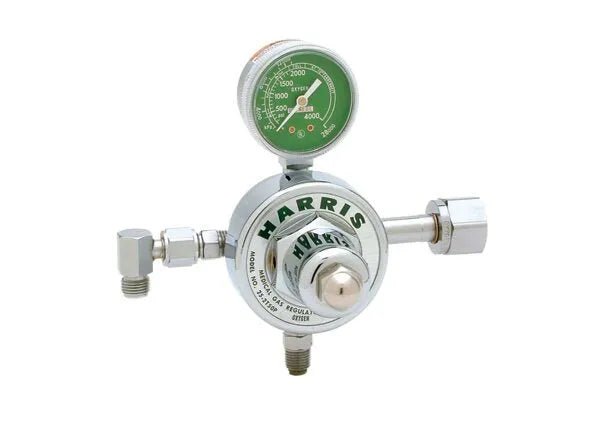 The Harris 25-2C T50P-326 Large Preset Regulator (3500626) has a round green gauge with white numbers on top, three metallic connectors, a central adjusting knob, and displays the Harris brand name for medical anaesthesia use.