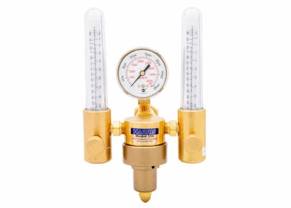 A brass dual flowmeter regulator with two vertical glass flow meters, a central pressure gauge, and labeled HARRIS Model 355. This argon helium flowmeter is used for controlling and measuring precise gas flow rates.
