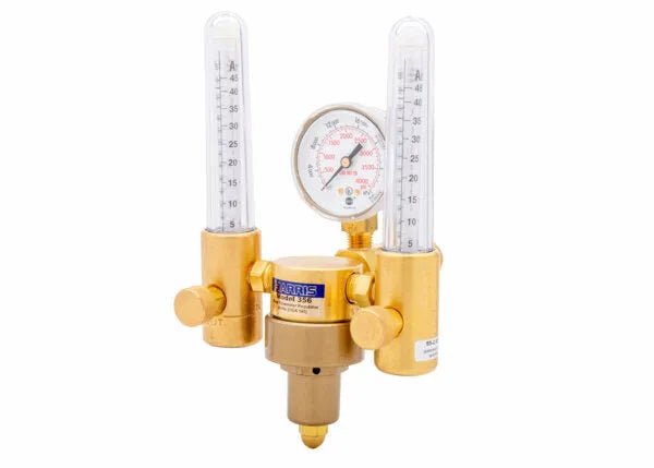A brass Harris Model 356 dual flowmeter regulator with clear vertical tubes and a central pressure gauge, ideal for welding or laboratory gas control. Features adjustment knobs on each side and is perfect as an argon helium flowmeter.
