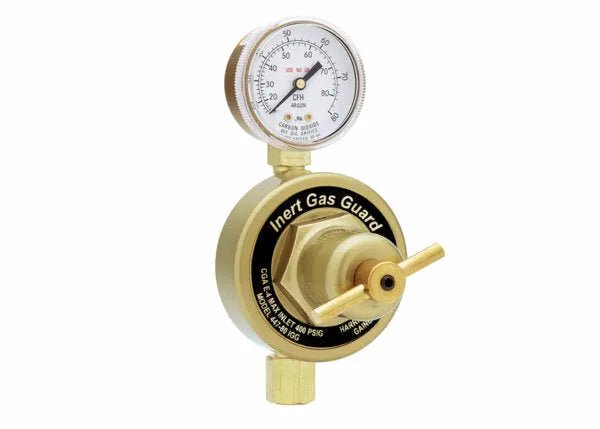 A brass Pipeline inert gas regulator with a pressure gauge on top, labeled Inert Gas Guard. The gauge has color-coded markings and the regulator, similar to the Harris Model 447, features a horizontal adjustment handle for shielding gas flow control.