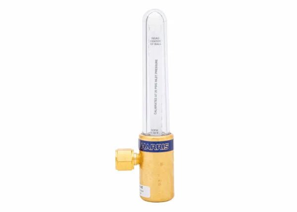 A compensated flowmeter made of brass with a clear vertical tube, measurement markings, and a control knob labeled “Harris,” designed for precise flow control in gas-shielded arc welding applications.