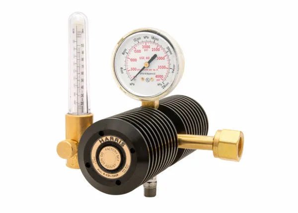 The Harris 3100090 - 6-cd-100f-320 is a high-capacity two stage CO2 flowmeter regulator in brass and black, with cooling fins, a round psi/kPa gauge, vertical glass flowmeter tube, large threaded connector—ideal for demanding applications.