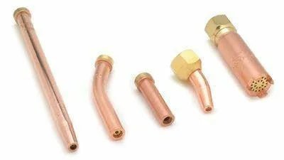 Five welding torch tips of various lengths and shapes, including a Harris gouging tip, are made of copper with brass fittings and arranged side by side on a white background.
