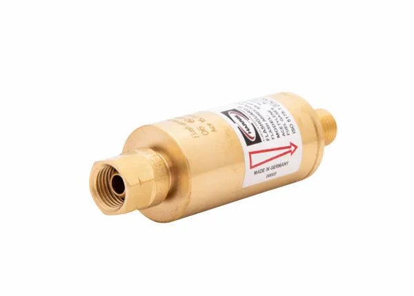A brass inline valve with threaded ends and a label indicating flow direction with a red arrow, commonly used in plumbing, HVAC systems, or as a regulator-type flashguard for fuel gas applications.