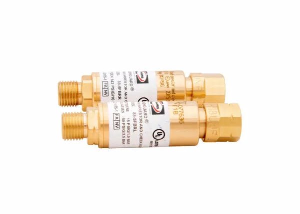 Two cylindrical brass check valves, designed as regulator-type flashguards for oxygen and fuel gas, with threaded ends and white labels featuring text and certification logos, placed parallel to each other on a white background.
