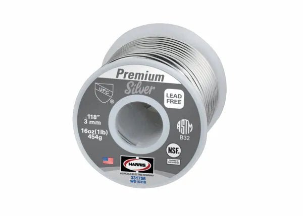 A 25 lb box of Harris 331756 Premium Silver Lead-Free Solid Wire Solder, 0.118 in (3.0 mm) thick, offers an eco-friendly solution for plumbing projects. The gray label features the Harris logo, certifications, an American flag, and product info.