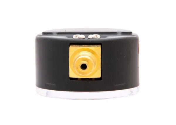 Close-up of a black and gold regulator pressure gauge featuring a central circular port and two small metal connectors on top, set against a white background.
