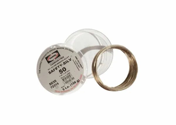 A coiled Harris 5035 - Safety-Silv 50 Silver Brazing Alloy (1/16 in, 5 troy oz cup) lies next to a clear plastic container; its cadmium-free label shows The Harris Products Group logo.