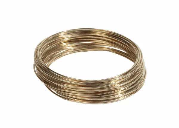 A coil of Harris 50N31 - Safety-Silv 50N Silver Brazing Alloy (1/16 in, 1 toz cup) is neatly looped on a white background, its smooth, golden-brass surface reflecting light.