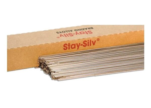 A bundle of Harris Stay-Silv 15 Phos-Copper Brazing Alloy 3/32 SQ x 36 rods is partially removed from a long box labeled “Stay-Silv” in red text. The silver-colored rods are stacked together against a plain white background.