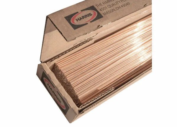 A partially opened Harris Stay-Silv 15 Phos-Copper Brazing Alloy box (3/32 in, 25 lb) shows shiny rods inside, used as HVAC filler metal for air conditioning refrigeration applications.