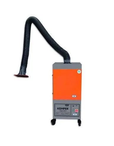 An orange and gray weld fume extractor with a flexible black hose and suction nozzle on top, mounted on wheels. The KEMPER brand is visible on the front panel. Features a self-cleaning filtration system for efficient operation.