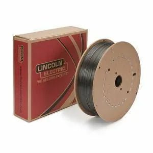A spool of welding wire sits next to a cardboard box labeled Lincoln Electric. The box is mostly red with tan accents, and both items are placed against a white background.