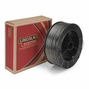 A spool of Lincoln 1/16 METALSHIELD MC-90 33SP (FB) ED033906 welding wire sits next to a rectangular red and tan Lincoln Electric box displaying the company’s logo and slogan, with shiny metallic wire wound on the black spool.