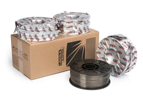 Several rolls of welding wire, including E71T-12C suitable for FCAW-G with CO2 shielding gas, are displayed around a brown Lincoln Electric box featuring a black logo and stylized spark graphic.