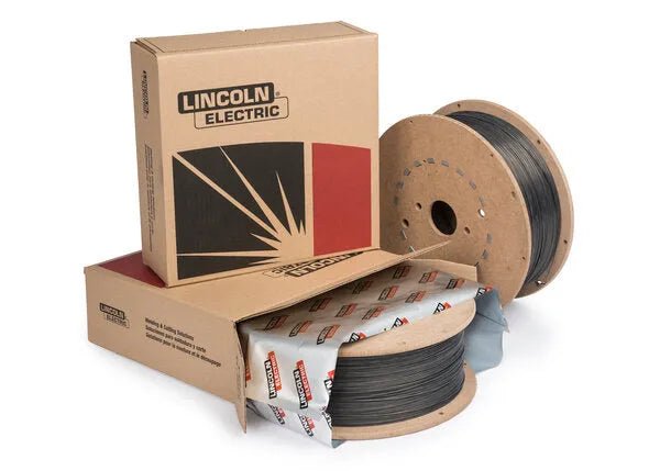 Two large spools of Flux-Cored welding wire, one partially unwrapped, are shown next to two cardboard Lincoln Electric boxes. The boxes have branding and a graphic with red, black, and beige colors—ideal for seismic structural fabrication.