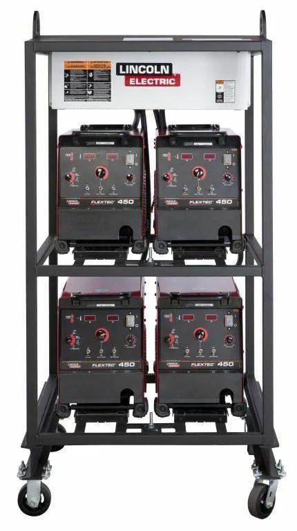 The Lincoln 4-PACK RACK FLEXTEC 450 K2956-2 is a metal cart with four Flextec 450 welders on industrial-grade racks, two per shelf. It features a white top panel with the Lincoln logo, black and red fronts, control knobs, and four caster wheels for mobility.