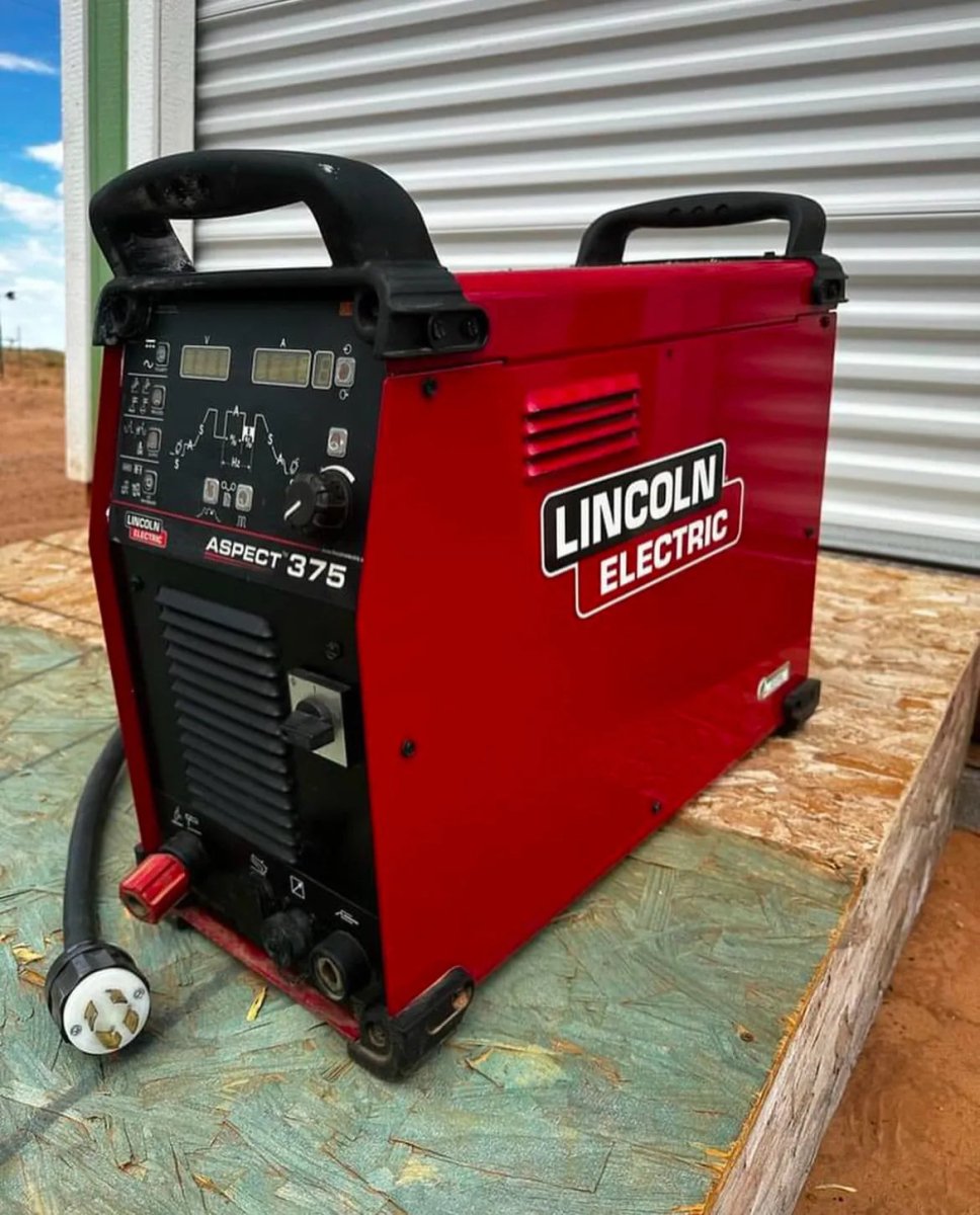 Lincoln Aspect 375 AC/DC TIG Welder (U3945-1) demo, red welding machine with controls and cables, at WeldingMart outdoors.